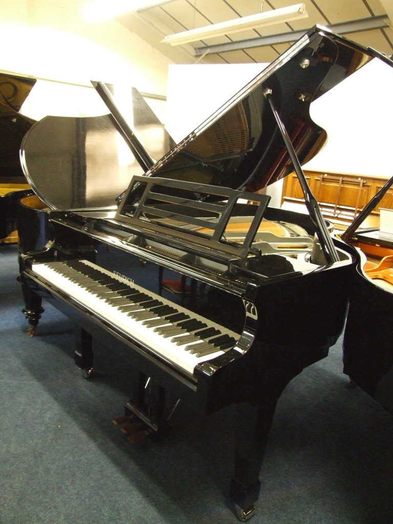 Feurich grand piano in bright black side view